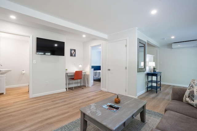 living room with light hardwood / wood-style floors and a wall mounted AC