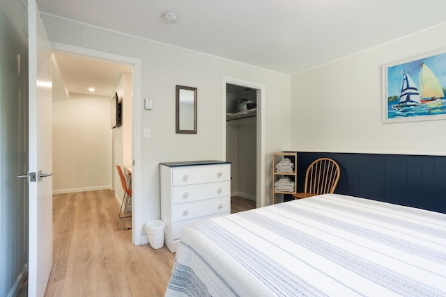 bedroom with a closet and light hardwood / wood-style floors