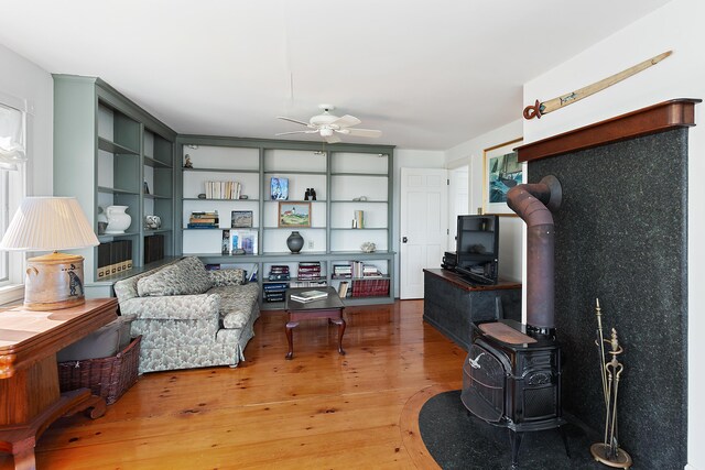 95 Pumpkin Cove Rd, Bristol, ME 04554 - interior space with hardwood / wood-style flooring, a wood stove, and ceiling fan