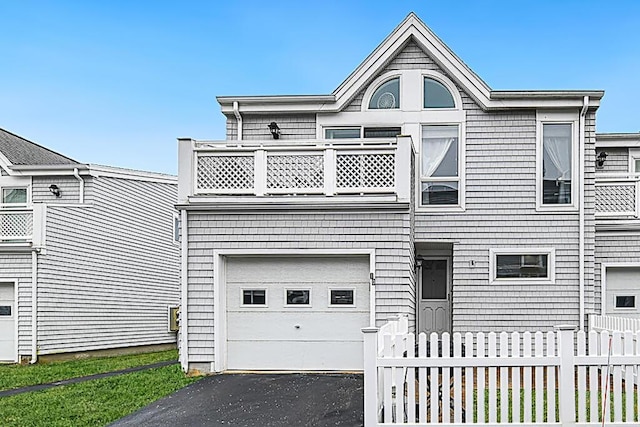 view of front of home featuring a garage and a balcony