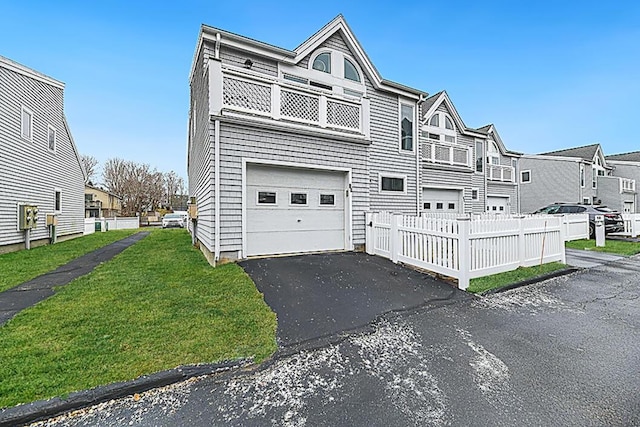 view of property with a front lawn and a garage