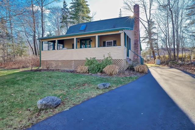 view of front of property with covered porch and a front yard