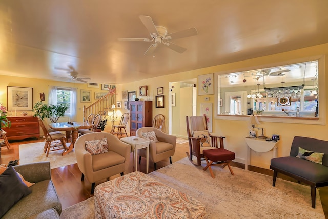 living room featuring hardwood / wood-style floors and ceiling fan