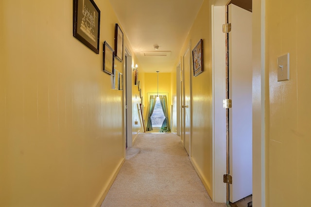 hall with light colored carpet