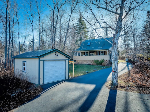 ranch-style house with covered porch, a garage, a front lawn, and an outdoor structure