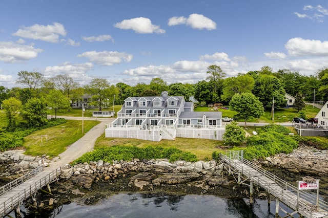 rear view of house with a deck with water view