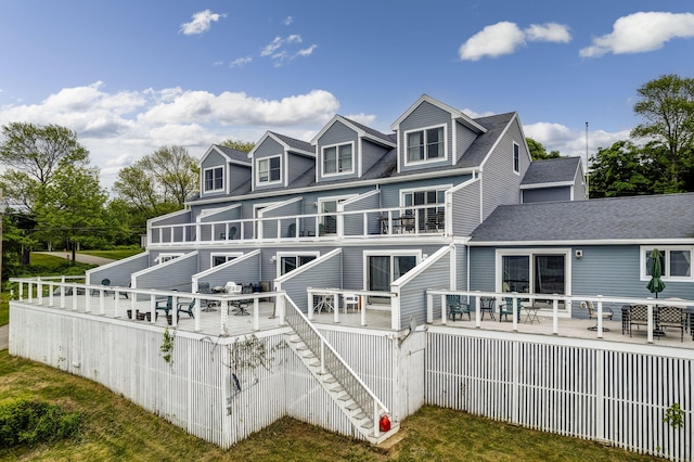 rear view of house featuring a wooden deck