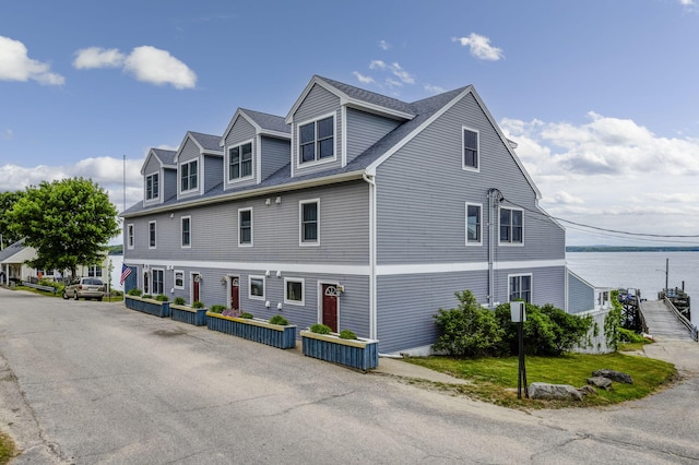 view of property exterior featuring a water view