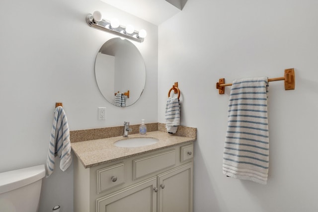 bathroom featuring vanity and toilet