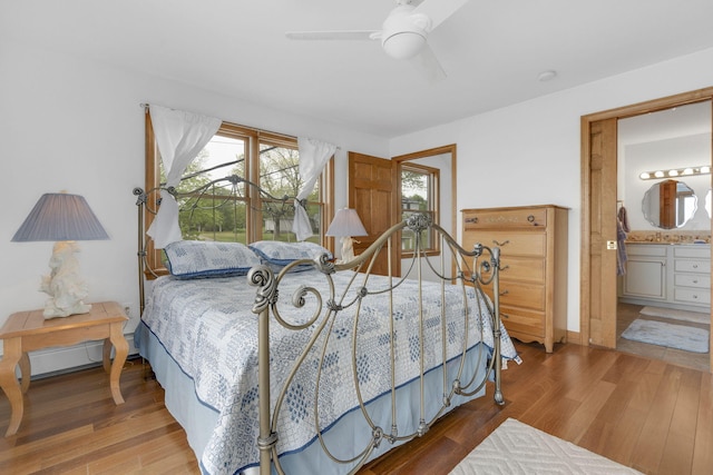 bedroom featuring connected bathroom, ceiling fan, and hardwood / wood-style floors