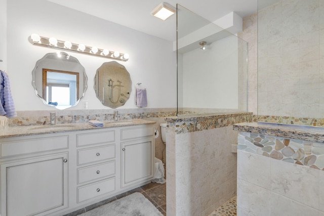 bathroom featuring tile patterned floors, vanity, and tile walls