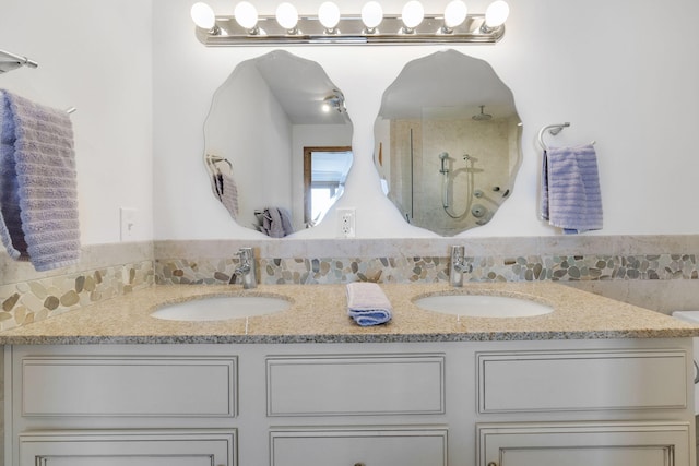 bathroom featuring a shower and vanity