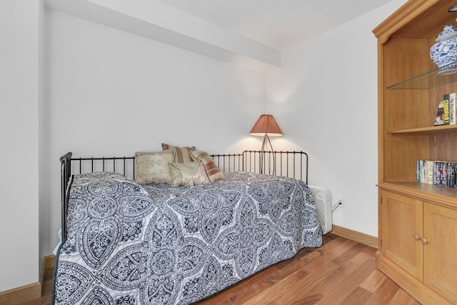 bedroom with hardwood / wood-style floors