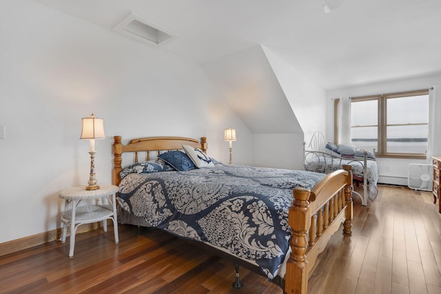 bedroom with lofted ceiling and wood-type flooring