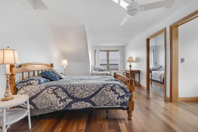 bedroom featuring ceiling fan, wood-type flooring, and lofted ceiling