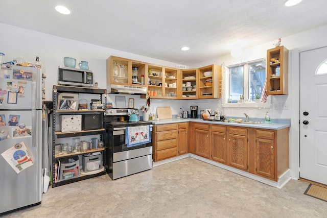 kitchen with sink, stainless steel appliances, and a textured ceiling