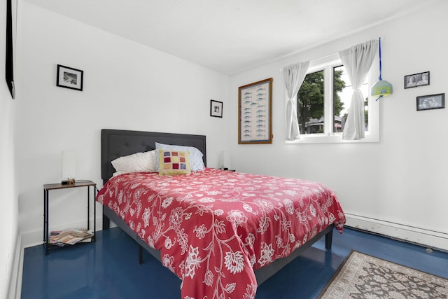 bedroom with concrete flooring and a baseboard heating unit