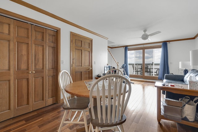 dining space with ceiling fan, ornamental molding, and dark wood-type flooring