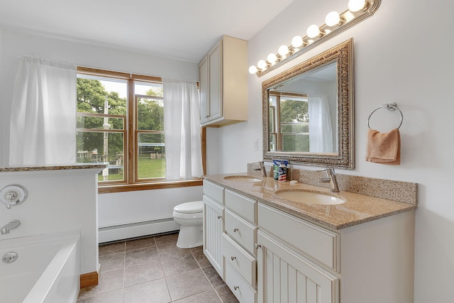 bathroom featuring vanity, baseboard heating, tile patterned flooring, toilet, and a tub