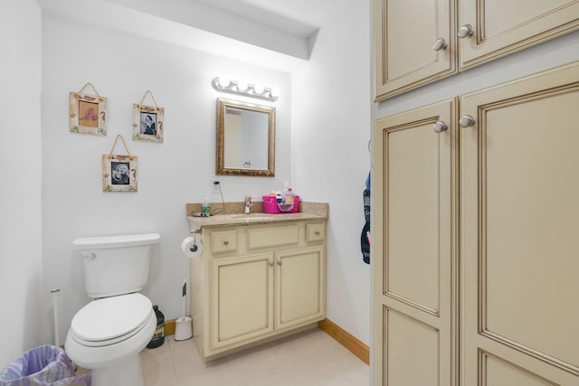 bathroom featuring tile patterned flooring, vanity, and toilet