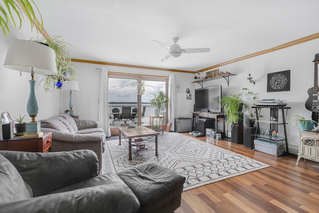 living room with ceiling fan, dark hardwood / wood-style flooring, and ornamental molding