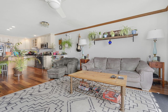 living room featuring hardwood / wood-style floors and crown molding