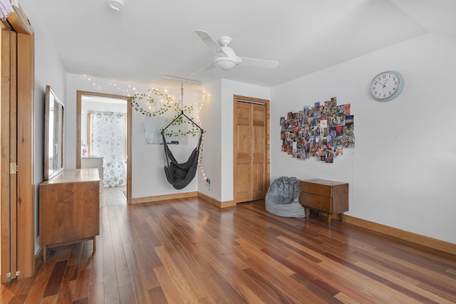 interior space featuring ceiling fan and dark wood-type flooring