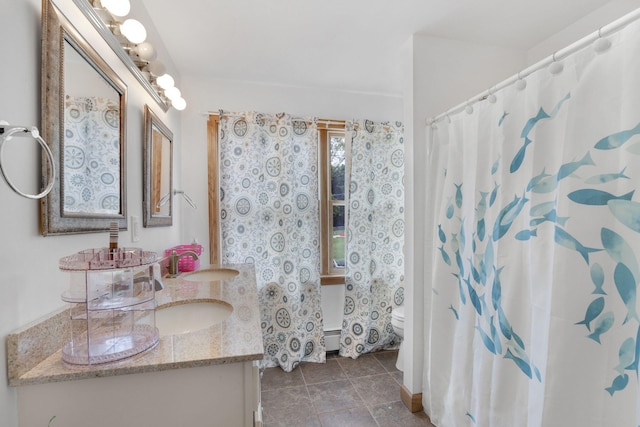 bathroom featuring tile patterned flooring, vanity, a baseboard radiator, and toilet