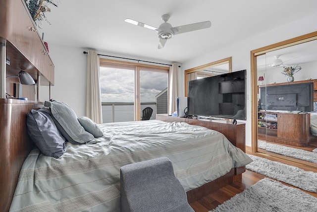 bedroom with wood-type flooring, access to outside, and ceiling fan