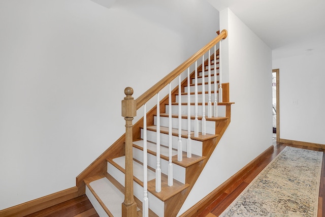 stairway with hardwood / wood-style flooring