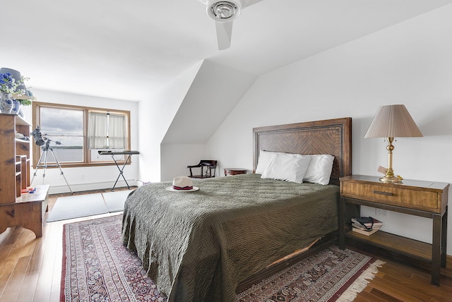 bedroom with ceiling fan, dark wood-type flooring, and lofted ceiling