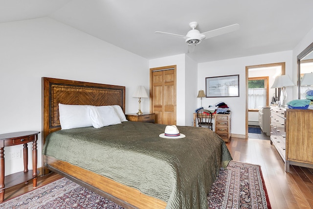 bedroom with hardwood / wood-style flooring, ceiling fan, lofted ceiling, and a closet