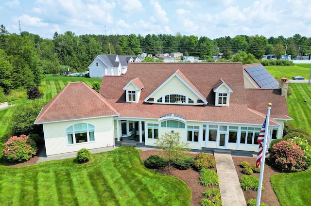 rear view of property featuring a yard