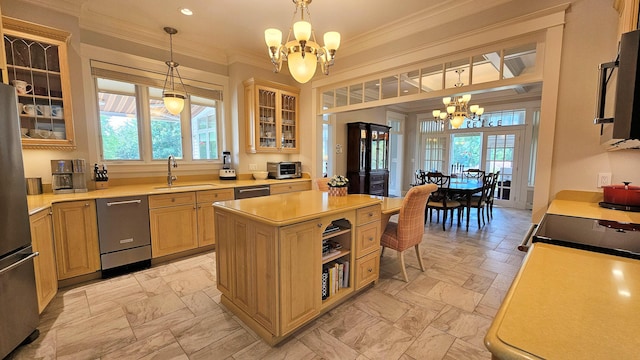 kitchen featuring a notable chandelier, a center island, sink, and appliances with stainless steel finishes