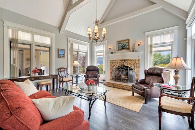 living room with a chandelier, beam ceiling, high vaulted ceiling, and a stone fireplace