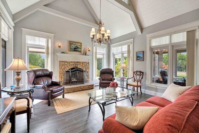 living room featuring beamed ceiling, a notable chandelier, a fireplace, and high vaulted ceiling