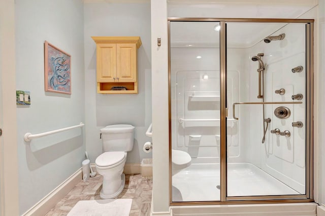 bathroom featuring toilet and an enclosed shower