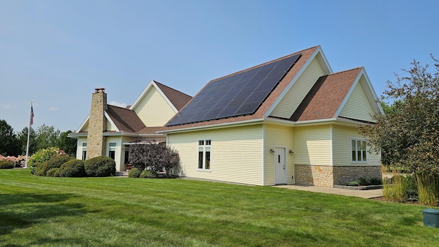 exterior space featuring a lawn and solar panels