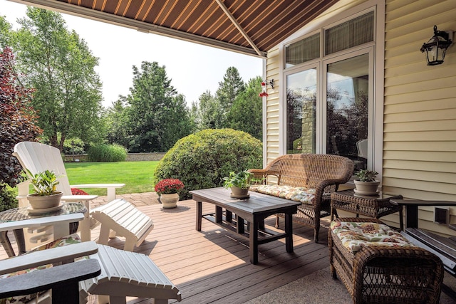 wooden deck featuring outdoor lounge area and a lawn