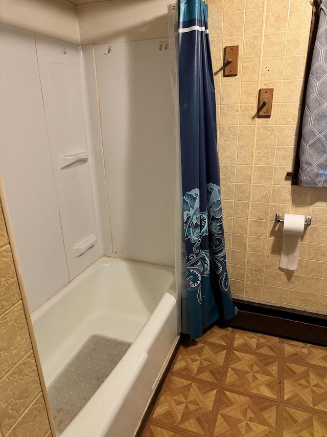 bathroom featuring shower / bath combination with curtain and parquet floors