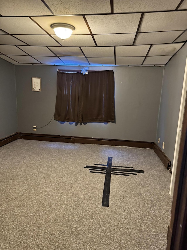 basement with a paneled ceiling