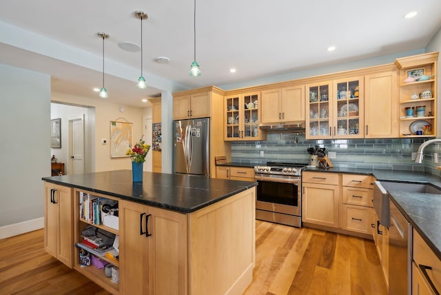 kitchen featuring light hardwood / wood-style flooring, light brown cabinets, appliances with stainless steel finishes, pendant lighting, and backsplash