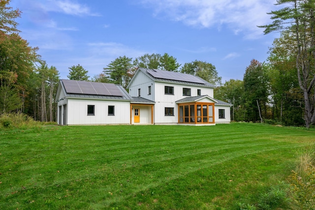 LOT10 Little Fawn Ln, Brunswick, ME 04011 - back of property featuring metal roof, solar panels, a sunroom, a yard, and a standing seam roof