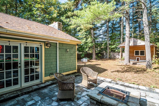 view of patio / terrace featuring an outdoor fire pit and french doors