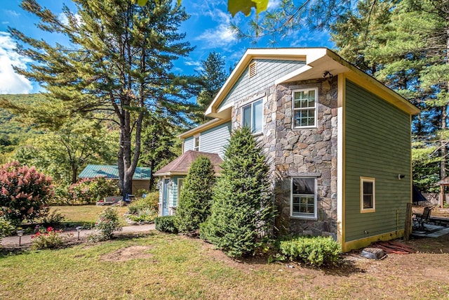 view of home's exterior with a lawn