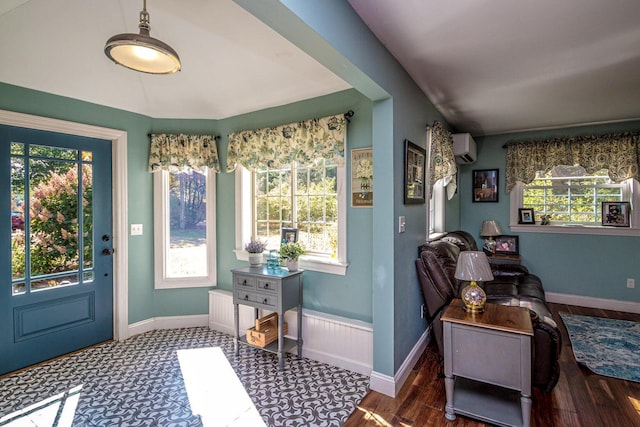 doorway with an AC wall unit and dark hardwood / wood-style floors