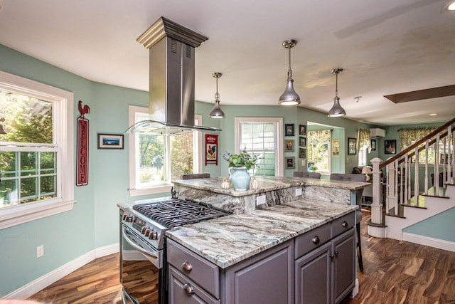 kitchen with dark hardwood / wood-style floors, island range hood, light stone counters, and high end stove