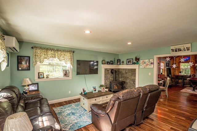 living room featuring a wall mounted air conditioner, dark hardwood / wood-style flooring, and a wood stove