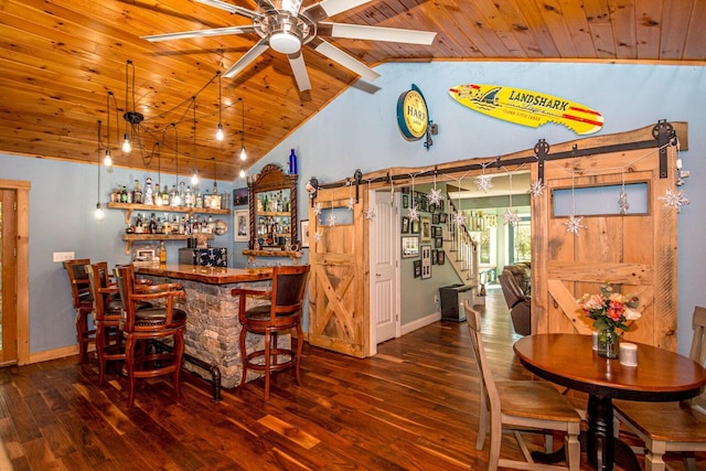 interior space featuring wood ceiling, ceiling fan, lofted ceiling with beams, dark hardwood / wood-style floors, and bar