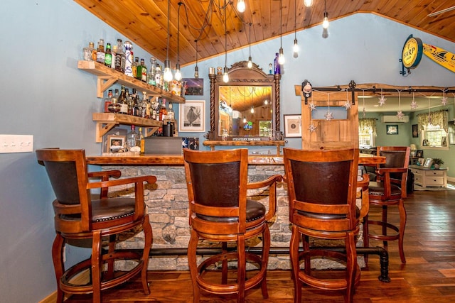 bar featuring hanging light fixtures, wooden ceiling, vaulted ceiling, and hardwood / wood-style flooring